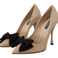 Beige Patent Leather Pumps with Black Bow