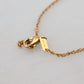 Elegant Gold Tone Charm Necklace with Cross Pendant
